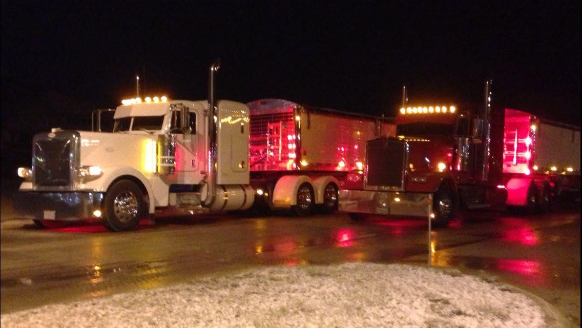 Hansen Trucking trucks parked at the yard at night