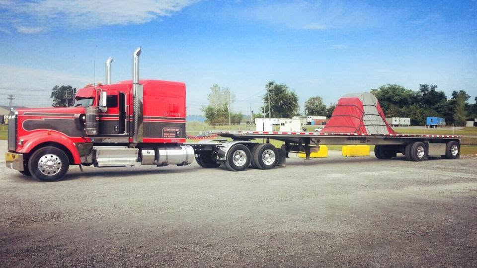 Red Hansen flatbed with steel coil load